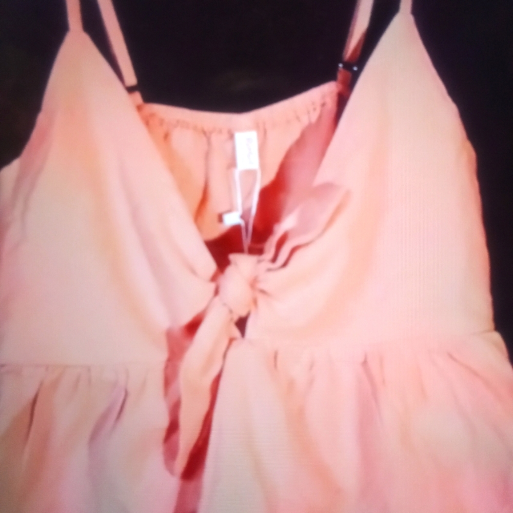 Peach colored crop top with tie & button back.